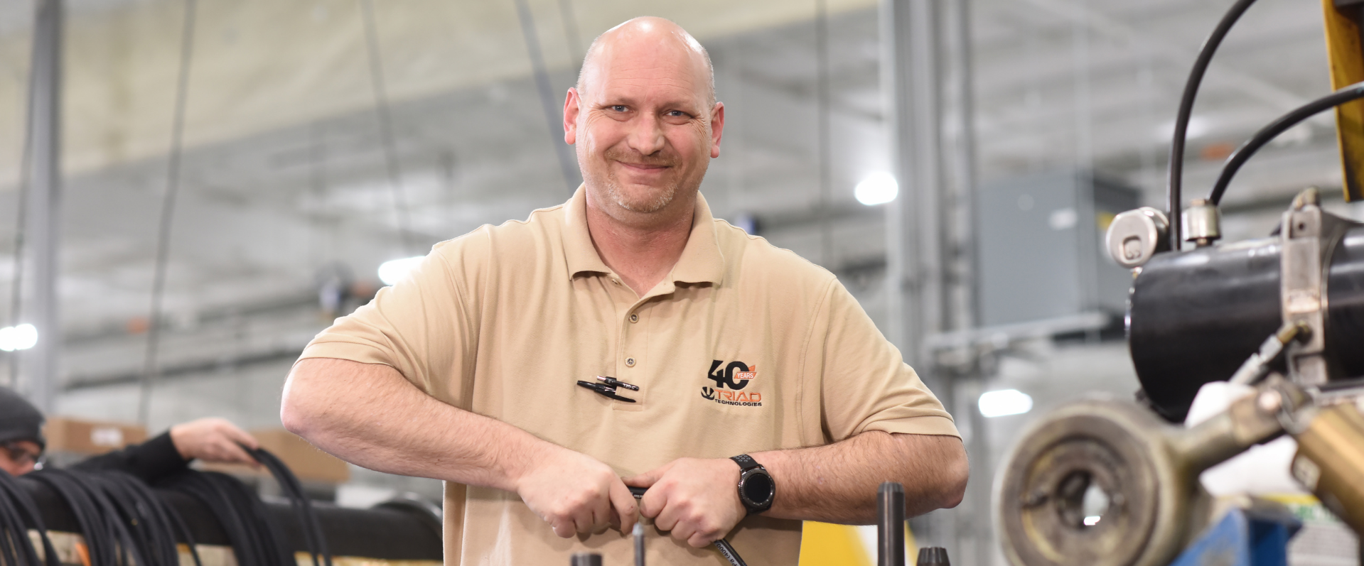 Triad employee assembling hose